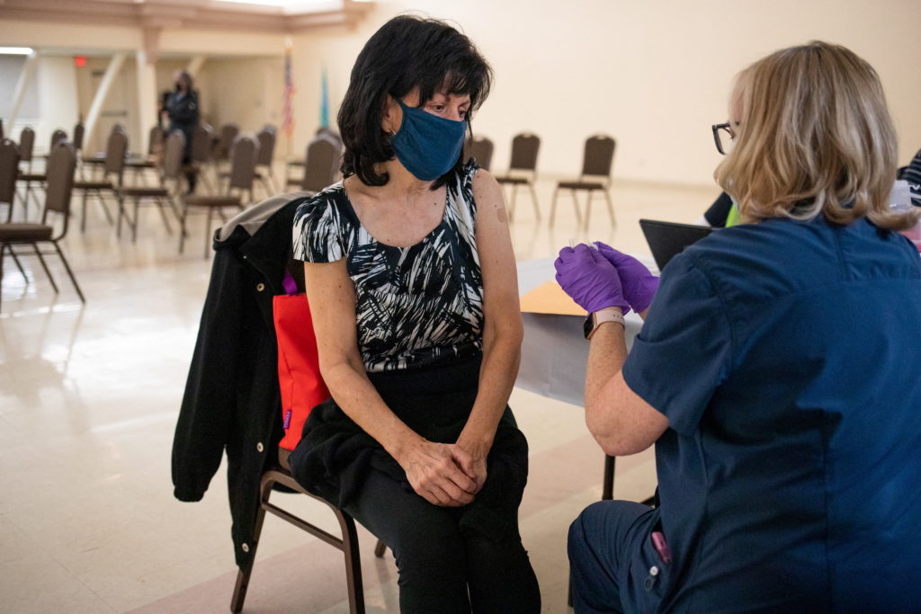 People receive their second COVID-19 boosters in Waterford, Michigan