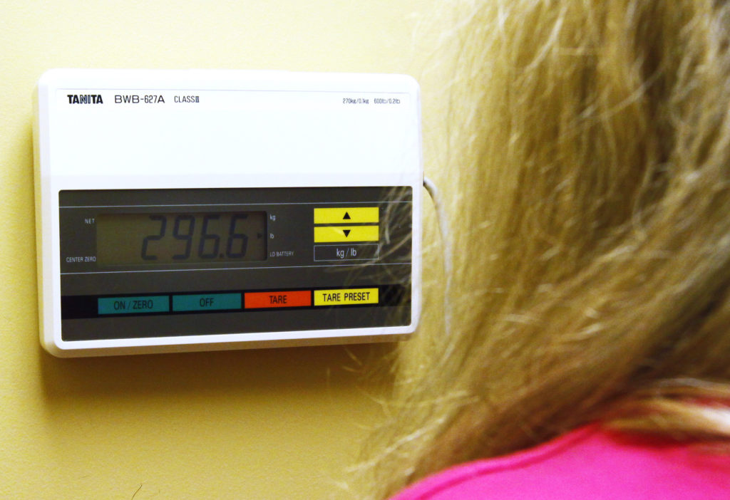Carolyn Dawson, a bariatric surgery patient looks at her weight reading in Denver