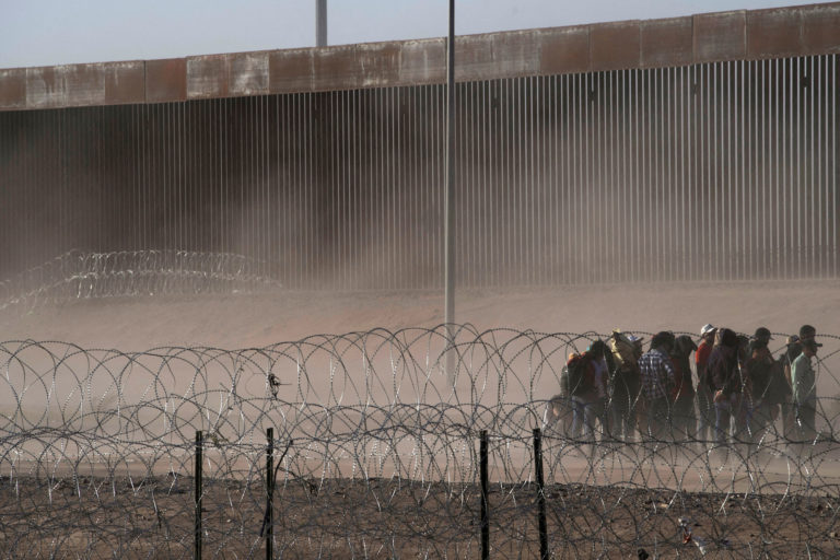 Migrants gather along the U.S. Mexico border near El Paso before the lifting of Tile 42