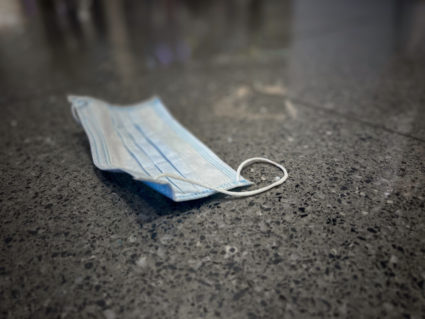 Disposable face mask on floor
