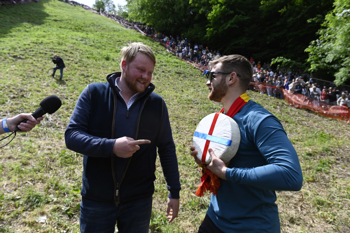 Contestants chase cheese wheel down a hill in chaotic U.K. race PBS News