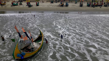 Drone view shows fishermen portaging their boats to safer ground due to Cyclone Mocha, in Teknaf Marine Drive, Cox's Bazar