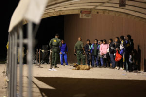 Migrants wait at the U.S.-Mexico border following the expiry of Title 42, in Yuma