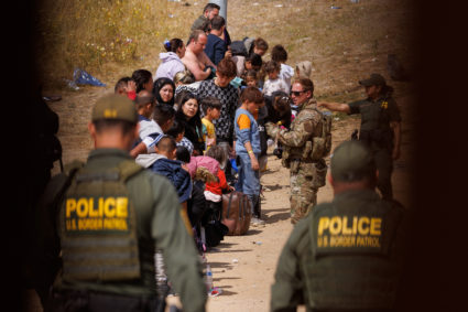 Migrants gather along the U.S. Mexico border near San Diego before the lifting of Tile 42