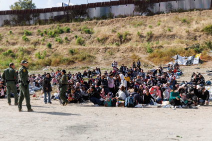 Migrants gather along the U.S. Mexico border near San Diego before the lifting of Tile 42