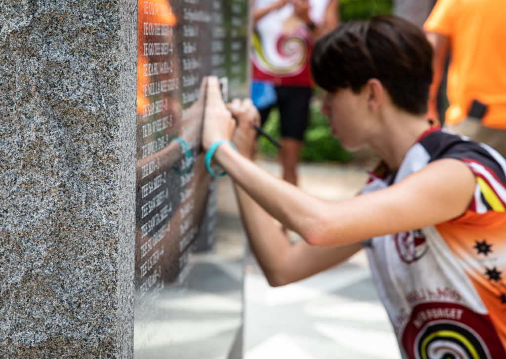 Participants in the 2019 Remember the Removal Ride etch names onto paper at the Blythe Ferry Memorial. Photos courtesy of the Cherokee Nation