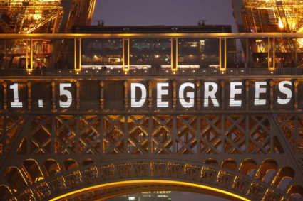 The slogan "1.5 Degrees" is projected on the Eiffel Tower as part of the World Climate Change Conference 2015 (COP21) in P...
