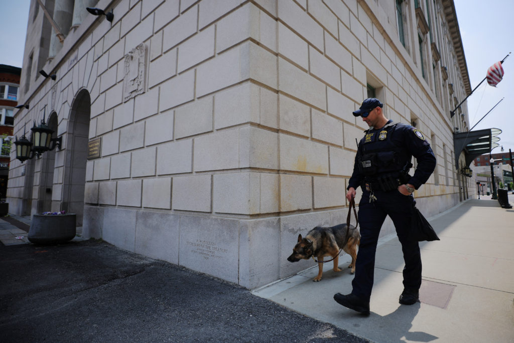 A police officer and dog patrol outside federal the courthouse before the detention hearing for Jack Douglas Teixeira, the US National Guardsman accused of leaking military secrets, in Worcester, Massachusetts, U.S., May 19, 2023. Photo by Brian Snyder/REUTERS