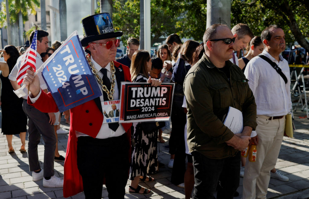 A supporter of former U.S. President Donald Trump stands outside The Wilkie D. Ferguson Jr. United States Courthouse, in M...