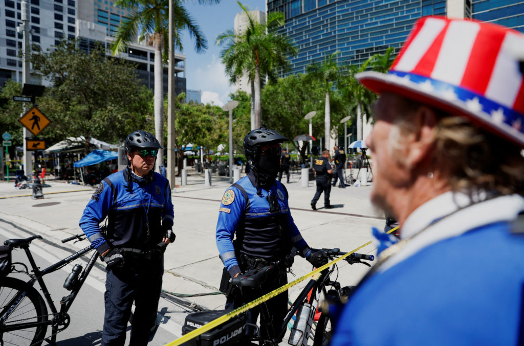 Police officers stand in a street cordoned with tape, after an unattended package was discovered on it, near the Wilkie D....