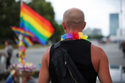 A person stands near an LGBT flag on the day of an annual LGBT Equality Parade in Warsaw, Poland June 17, 2023. Photo by Kacper Pempel/REUTERS