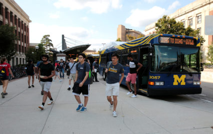 Students take the bus at the Central Campus Transit System at the University of Michigan in Ann Arbor