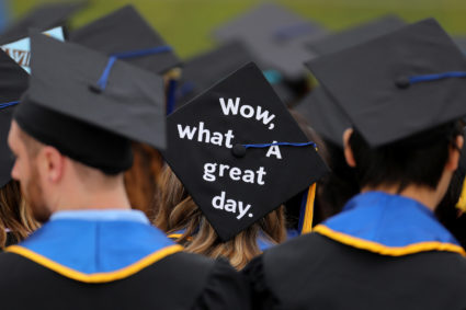 Messages and artwork are pictured on the top of the caps of graduating students during their graduation ceremony at UC San...