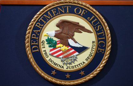 The Department of Justice seal is seen on a lectern ahead of a press conference announcing efforts against computer hacking and extortion at the Department of Justice in Washington, DC on November 28, 2018. (Photo by MANDEL NGAN / AFP) Photo by MANDEL NGAN/AFP via Getty Images