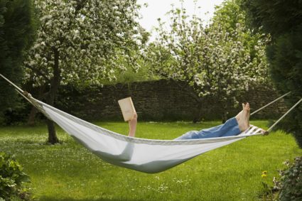 Woman in hammock reading book