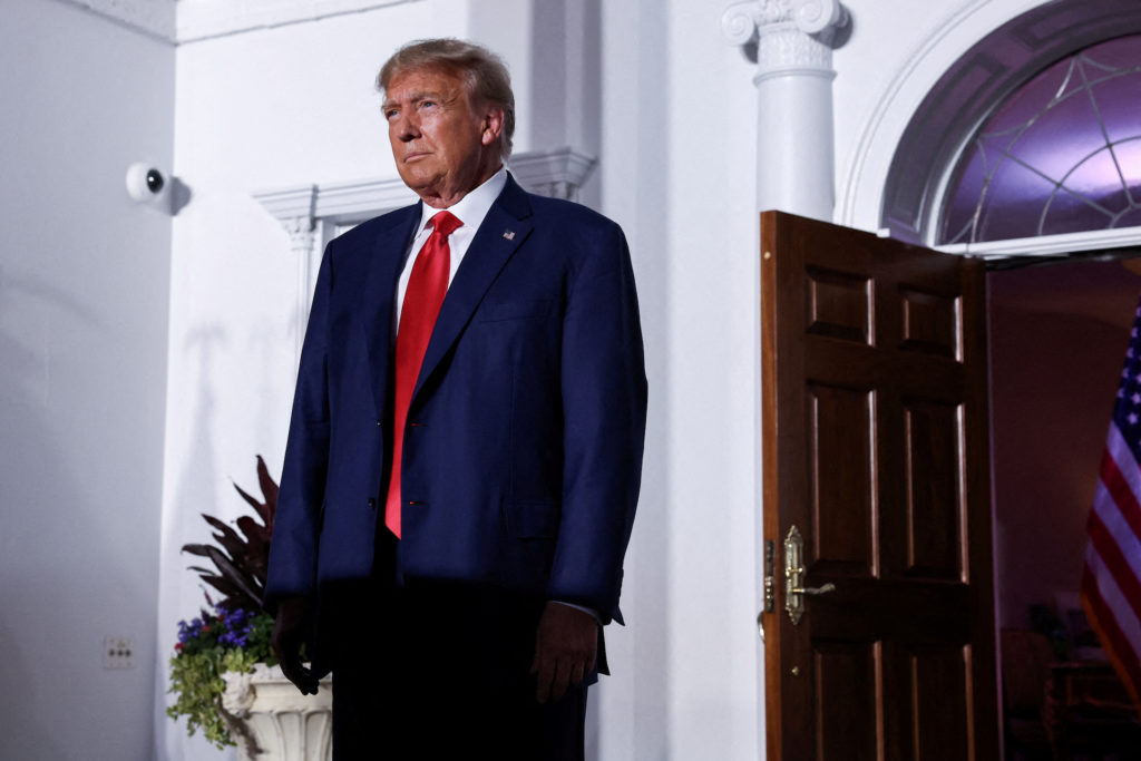FILE PHOTO: Former U.S. President Donald Trump reacts on stage following his arraignment on classified document charges, i...