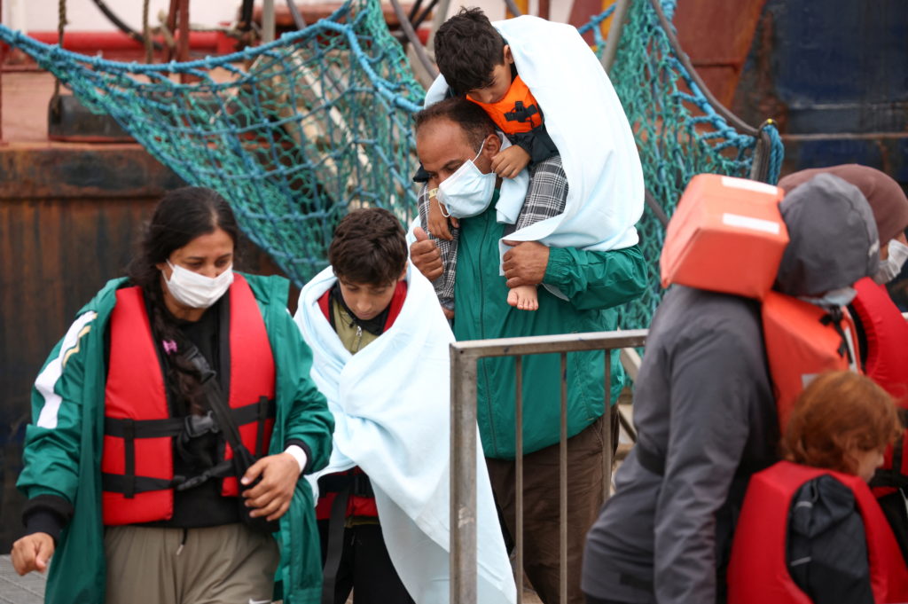 Migrants are escorted into Dover harbour, after being rescued while attempting to cross the English Channel, in Dover, Bri...