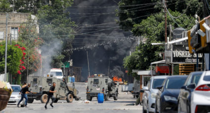 Palestinians clash with Israeli forces during an Israeli military operation in Jenin