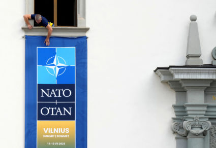 Worker installs NATO summit banner in Vilnius