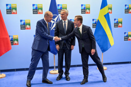 Turkish President Tayyip Erdogan and Swedish Prime Minister Ulf Kristersson shake hands next to NATO Secretary-General Jens Stoltenberg prior to their meeting, on the eve of a NATO summit, in Vilnius, Lithuania July 10, 2023. Henrik Montgomery /TT News Agency/via REUTERS