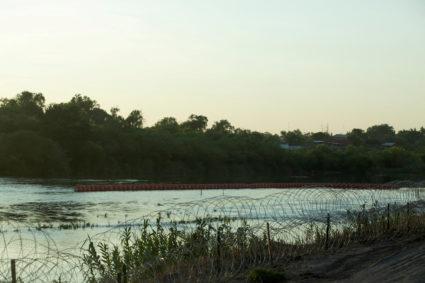 An unfinished strand of orange buoys sits in the Rio Grande River in response to migrants crossing the river, near Eagle Pass, Texas, U.S., July 11, 2023. Photo by Kaylee Greenlee Beal/REUTERS