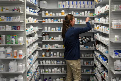 A technician stocks the shelves of the pharmacy at White House Clinic in Berea