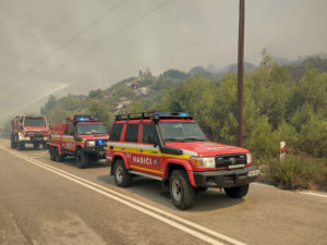 Firefighters try to extinguish a wildfire burning near Laerma, Rhodes Island