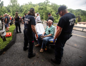 Emergency personnel tend to a rescued resident following flash flooding in Stony Point
