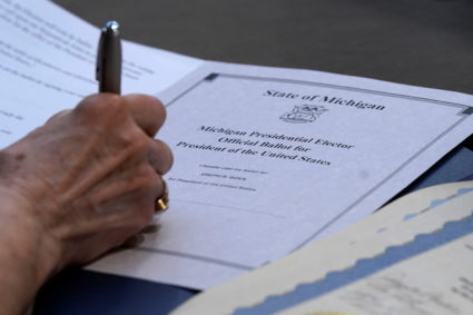 Electoral College elector Bobbie Walton signs her ballot for President of the United States at the state Capitol in Lansing, Michigan, U.S. December 14, 2020. Photo by Carlos Osorio/Pool via REUTERS