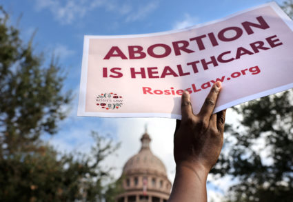 A supporter of reproductive rights holds a sign outside the Texas State Capitol building during the nationwide Women's March, held after Texas rolled out a near-total ban on abortion procedures and access to abortion-inducing medications, in Austin, Texas, Oct. 2, 2021. Photo by Evelyn Hockstein/REUTERS