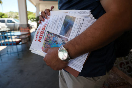Tim Laborte holds 'MISSING' flier featuring a photo of his stepfather in Hawaii