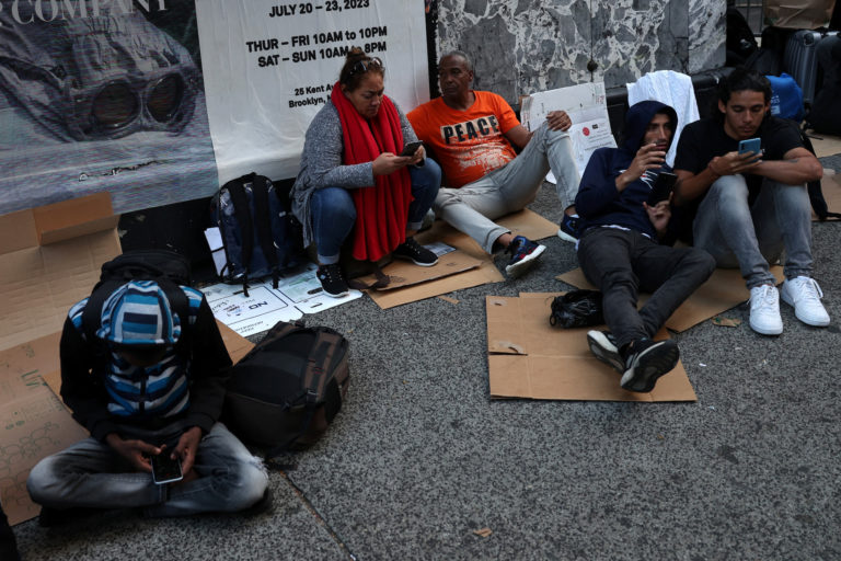 Recently arrived migrants to New York City outside Roosevelt Hotel in New York