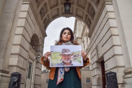 Roxanne Tahbaz holds a picture of her father during the