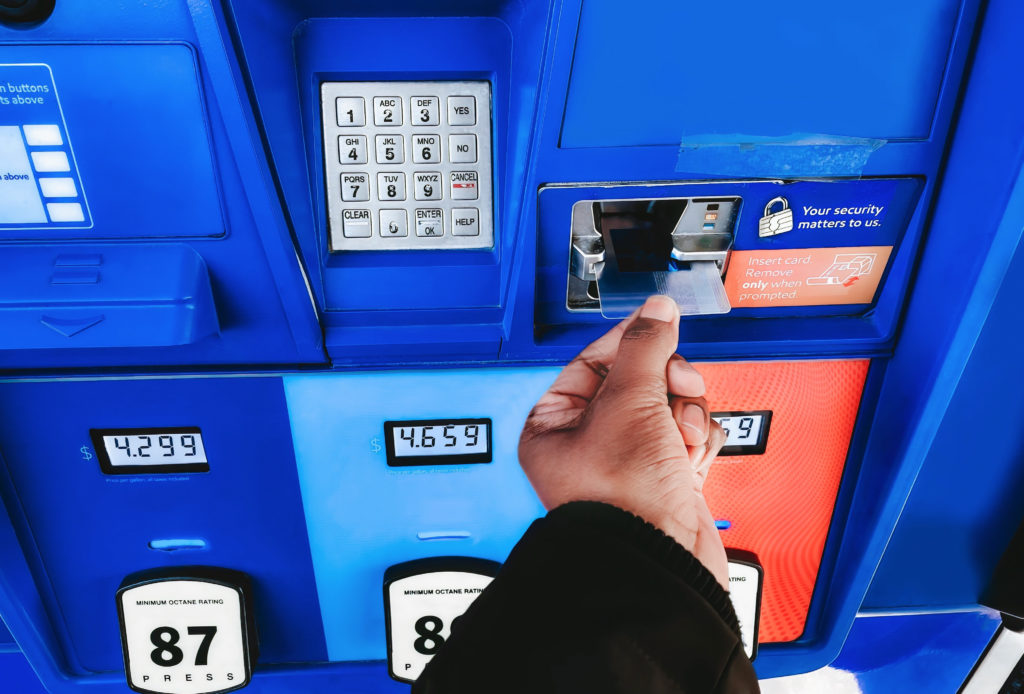 Woman Purchases Gas at Pump