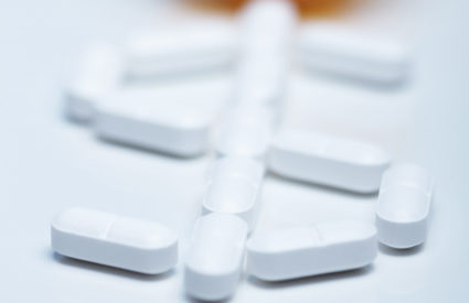 Pills forming a dollar symbol