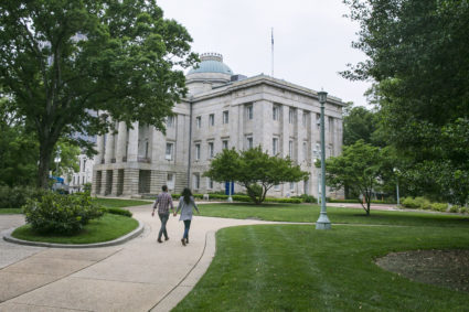 A couple walk near the North Carolina State Capitol in Raleigh, N.C., on Monday, May 9, 2016. Photo By Al Drago/CQ Roll Call