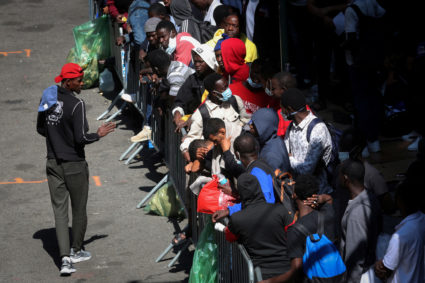 FILE PHOTO: Recently arrived migrants to New York City wait outside Roosevelt Hotel in New York