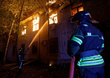 Firefighters extinguish a fire in the university building following a reported shelling in Donetsk