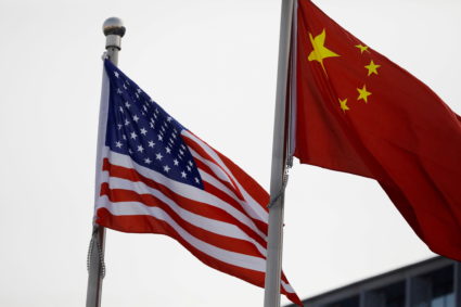 Chinese and U.S. flags flutter outside the building of an American company in Beijing, China January 21, 2021. Photo by Tingshu Wang/REUTERS