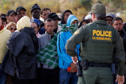 Migrants gather along the U.S. Mexico border near San Diego before the lifting of Title 42