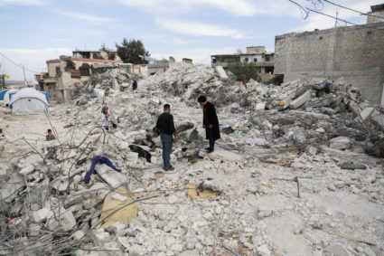 Intisar Sheikho, reacts as she stands on rubble of the building where her brother Musheer and his family lived, in the reb...