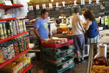 Dino Curovac of Bread Basket Bakery pushes a cart of bread at the Phoenix Public Market in Phoenix
