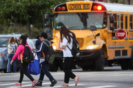 A family walks to school together on the first day of New York City Public Schools in Brooklyn, New York