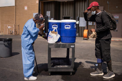 FILE PHOTO: Men drink water outside during heat wave in Houston, Texas