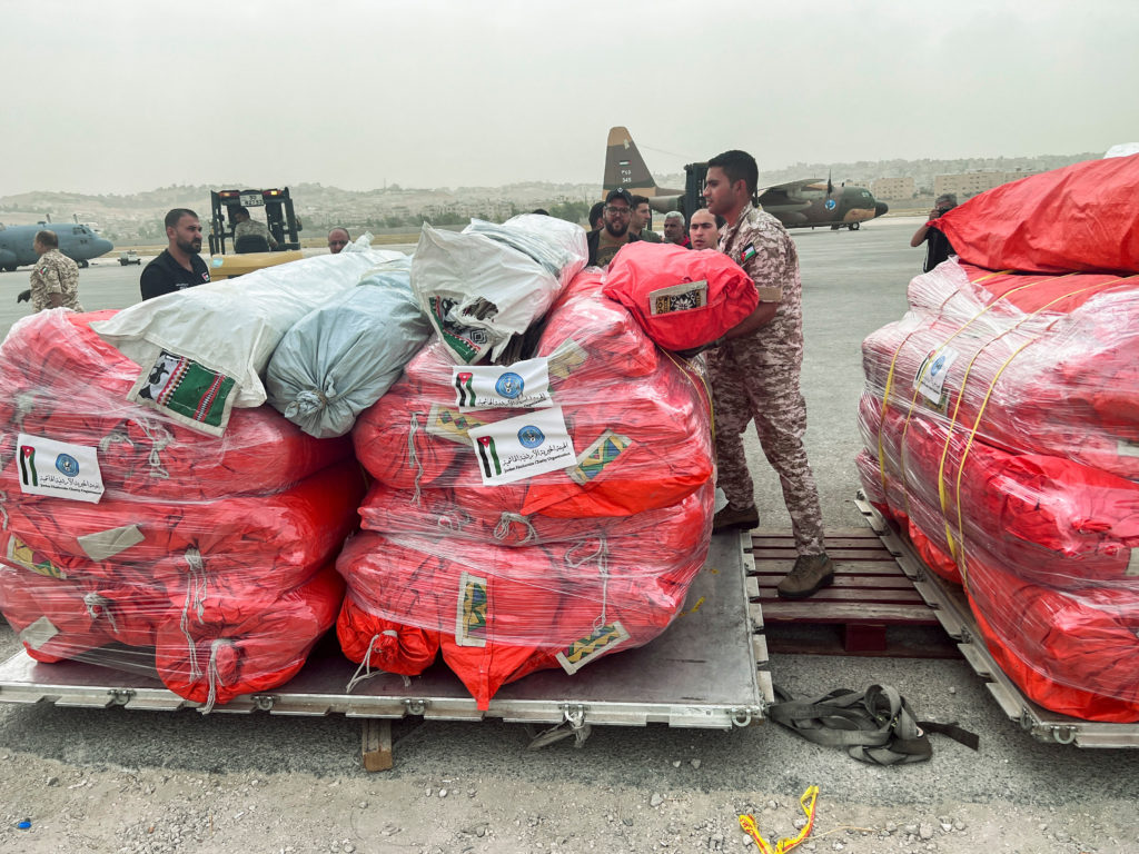 Jordanian military personnel arranges relief items from the Jordan Hashemite Charity Organization to be delivered, in Amman