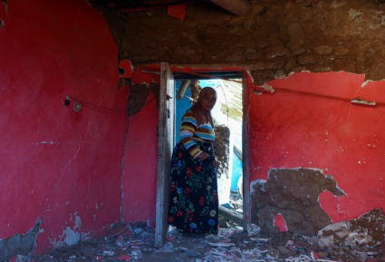 Ehouline Erkouch walks at her damaged home in the village of Outaghrri