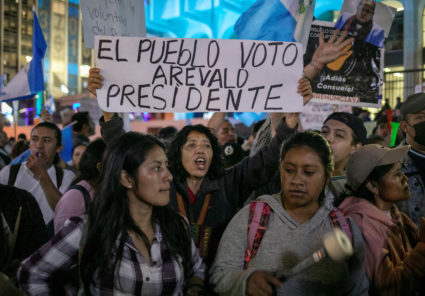 A protester holds a sign that reads "The people vote Arevald president" as supporters of Guatemalan President-elect Bernardo Arevalo protest outside the Supreme Court of Justice (CSJ), after he temporarily suspended his participation in the government transition following a raid on electoral facilities by the top prosecutor's office, in Guatemala City, Guatemala September 18, 2023. Photo by Luis Echeverria/REUTERS