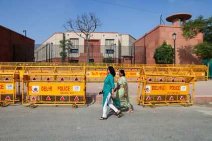 Women walk past India's new parliament in New Delhi, India, September 20, 2023. Photo by Anushree Fadnavis/REUTERS