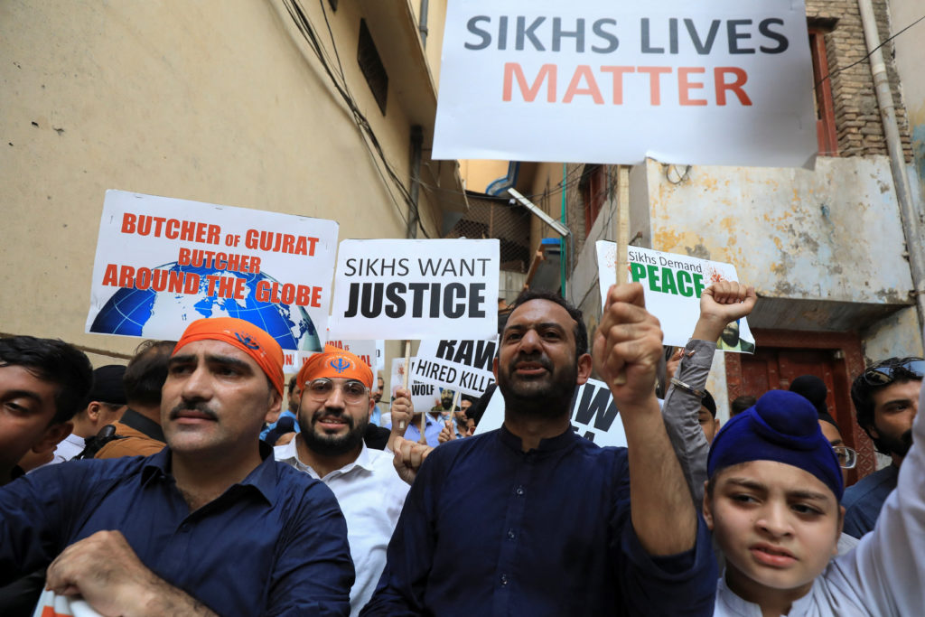 Members of the Pakistan’s Sikh community, chant slogans as they hold placards condemning the assassination of Sikh leader ...