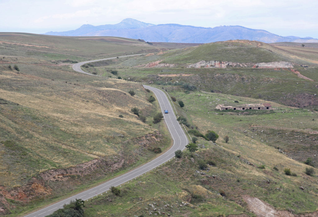 A vehicle drives along the road leading from Armenia to Azerbaijan's Nagorno-Karabakh region, near the village of Tegh